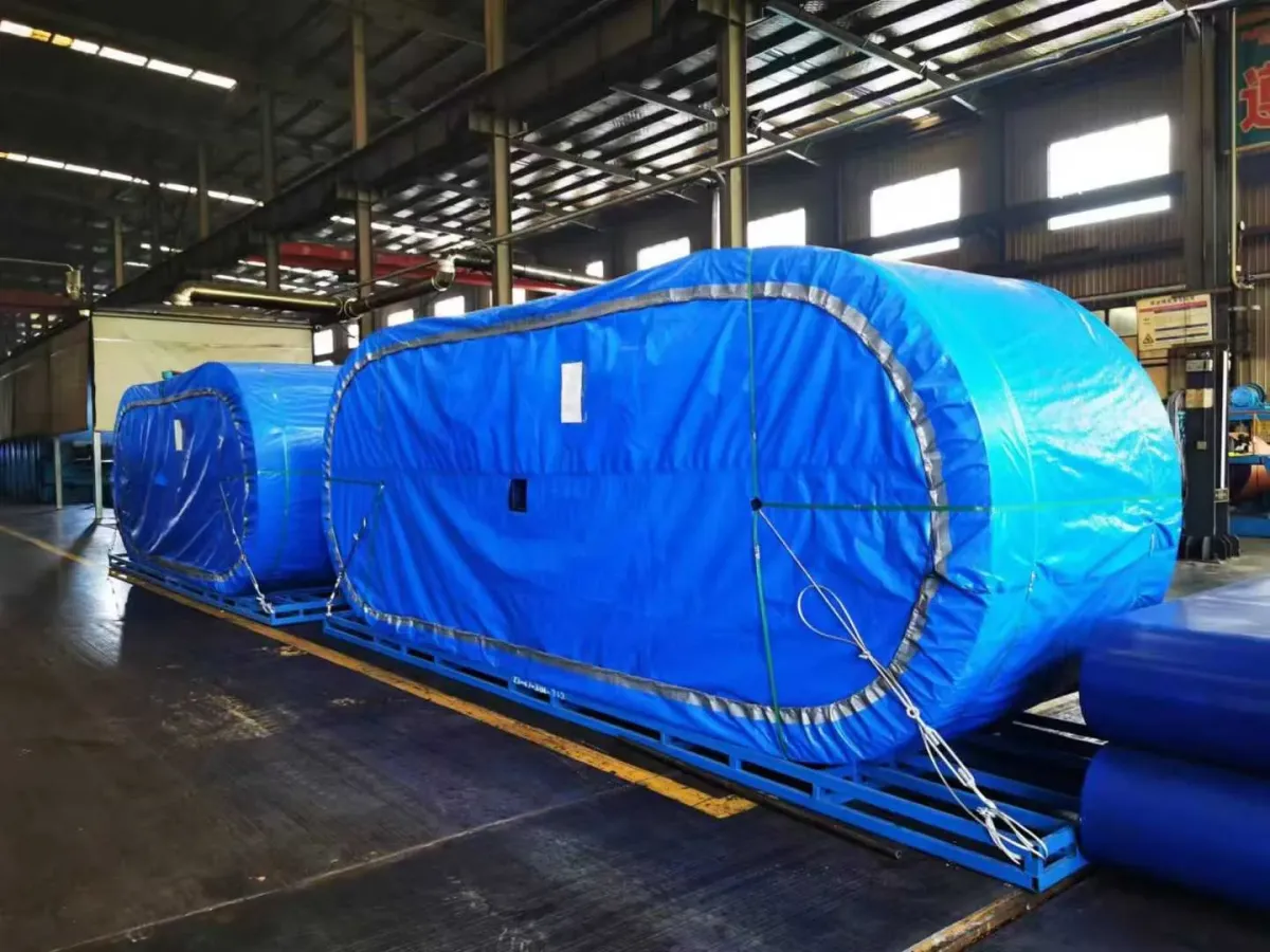 Covered conveyor belt rolls on support frames