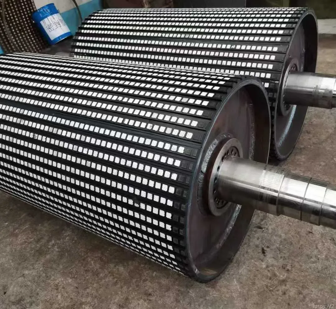 Conveyor pulleys with ceramic-block lagging and visible shaft ends